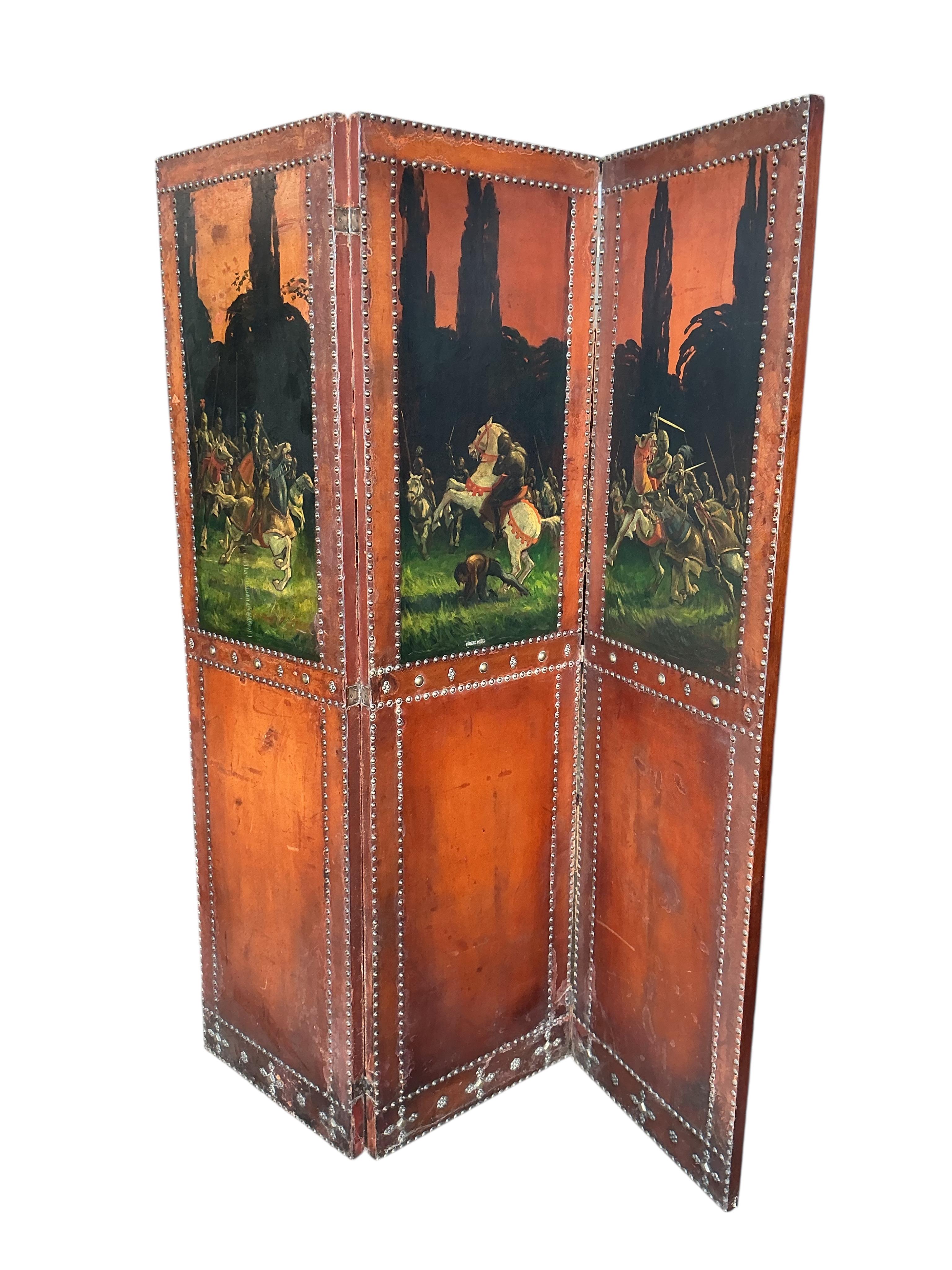 A painted leather and mahogany three fold dressing screen, each panel width 48cm, height 174cm